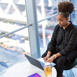 Businesswoman working on a laptop in a bright office